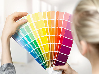 Women selecting colors from a color swatch book.